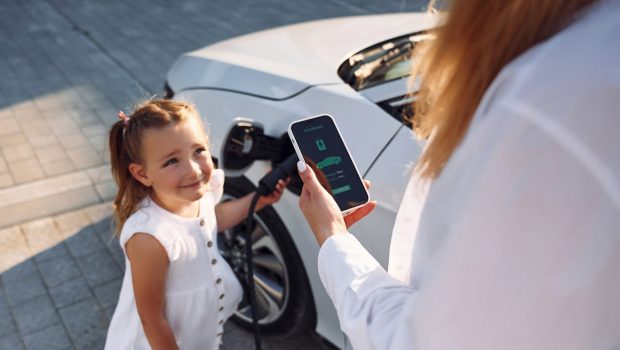 charging-the-vehicle-young-woman-with-her-little-2023-11-27-05-18-44-utc (1)